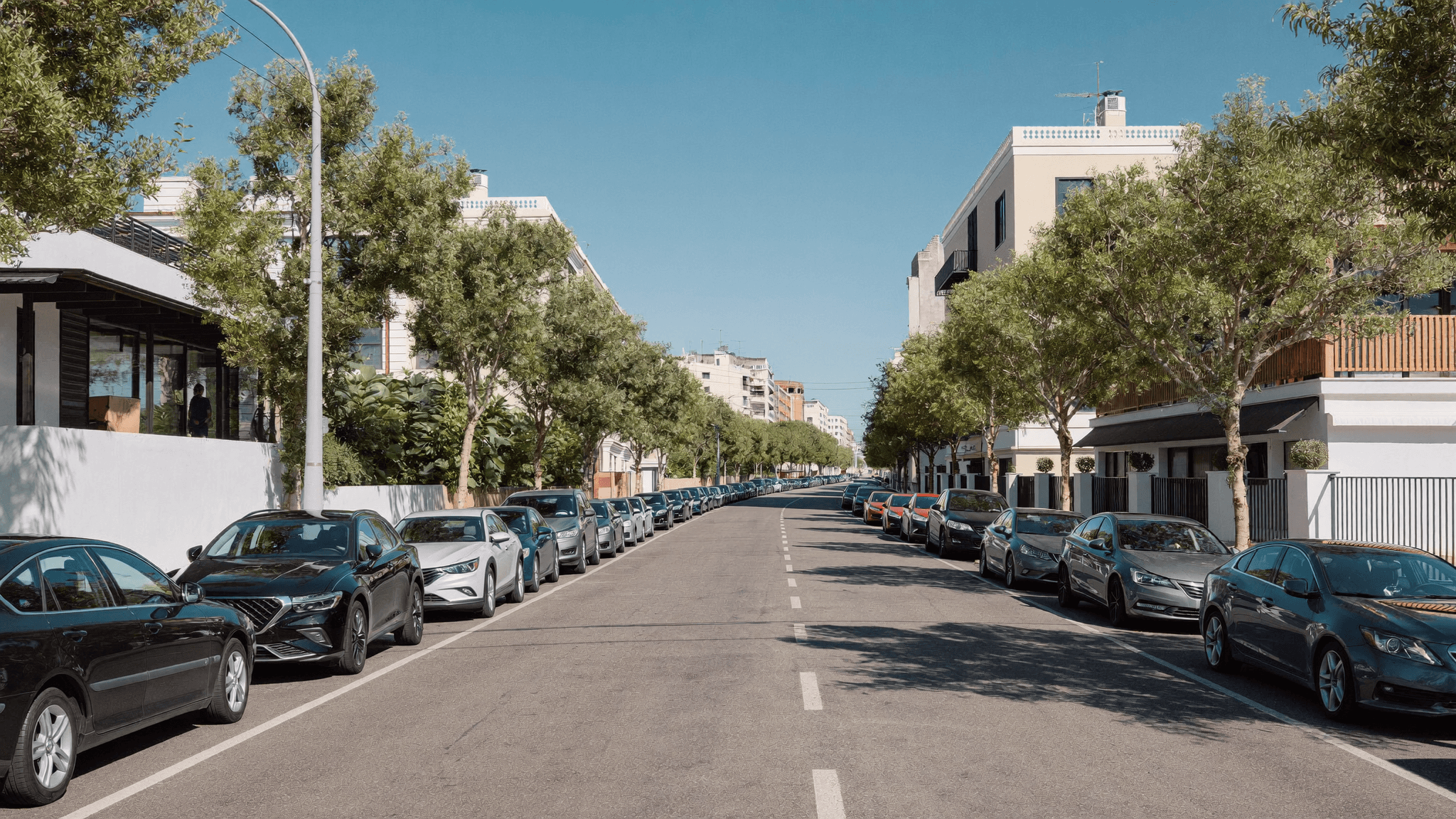 A sunny city street in Tirana with available parking